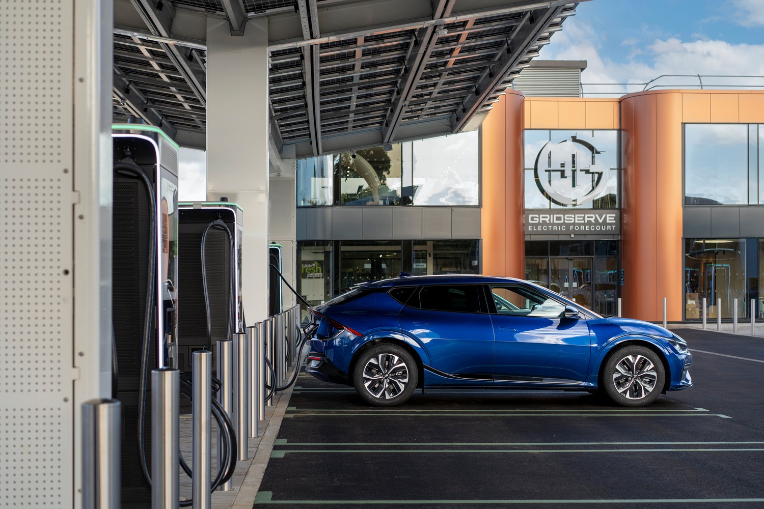 Blue electric car at a GRIDSERVE EV charging station