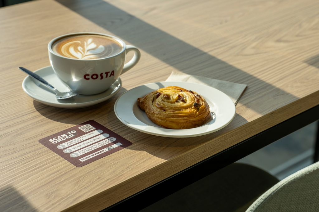 A drink and a treat on a table at GRIDSERVE Markham Vale Electric Forecourt